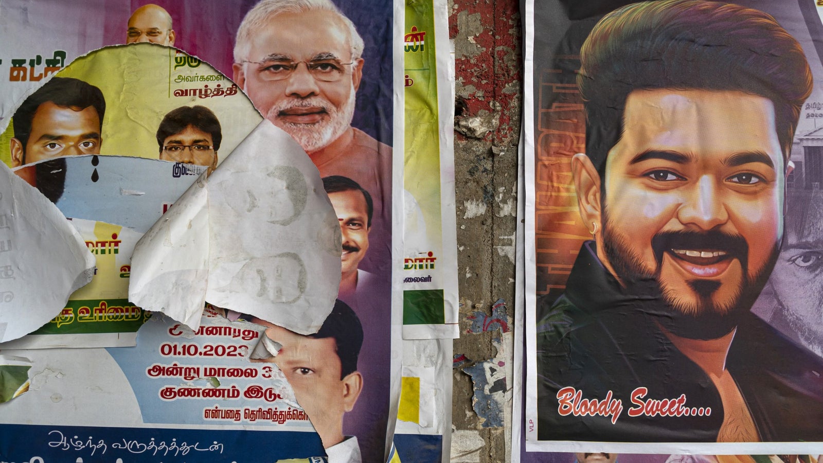 A photo showing political posters on a wall.