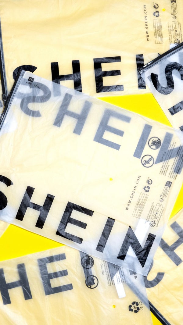 A photo showing a cluster of Shein shipping bags laid out on a yellow background.
