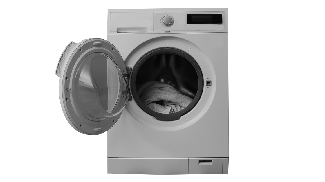 A front-loading washing machine with an open door, showing a pile of white laundry inside the drum.