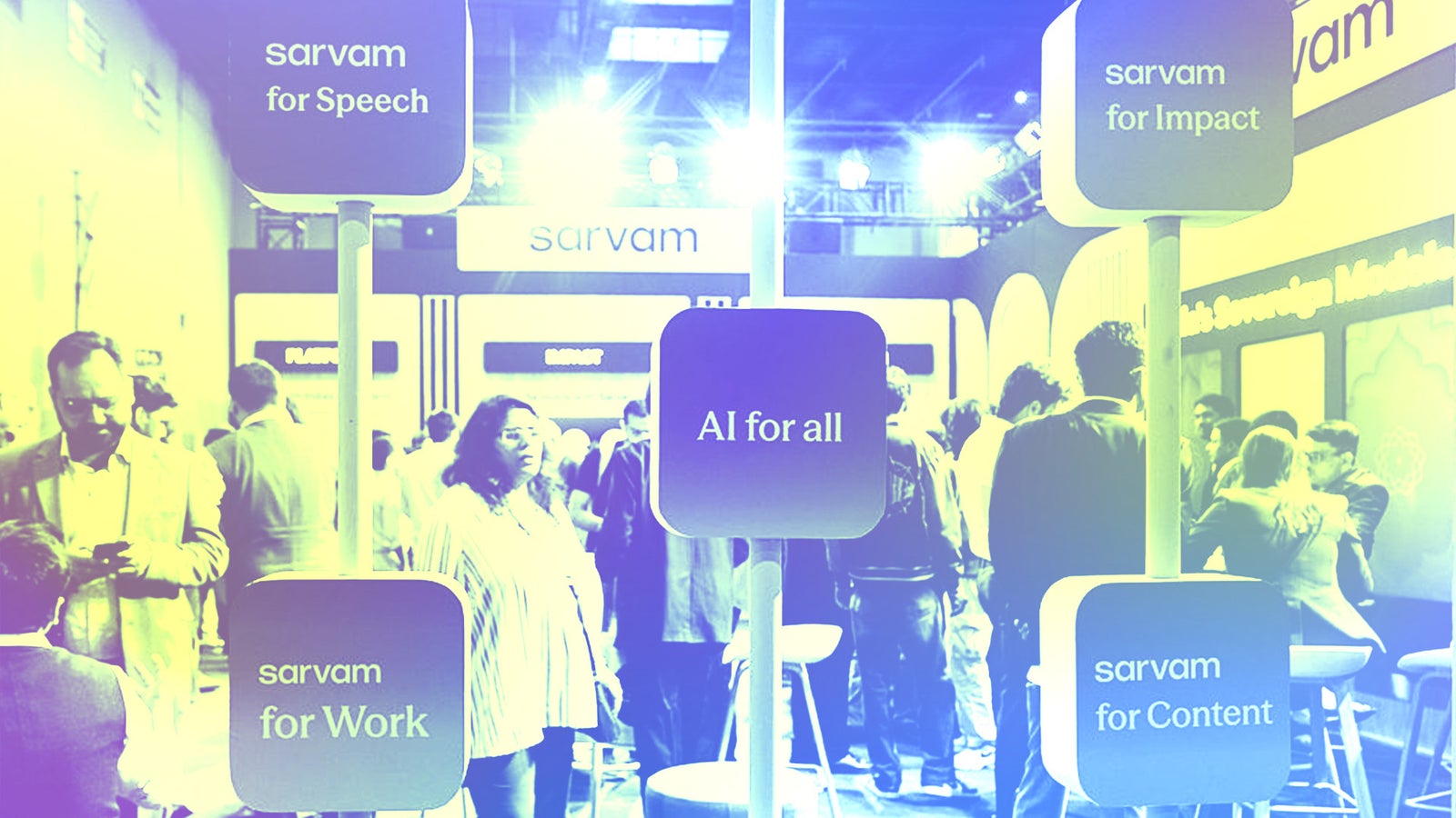 A busy tech event with people interacting, featuring signs that read "sarvam for Speech," "sarvam for Impact," "AI for all," and "sarvam for Content."