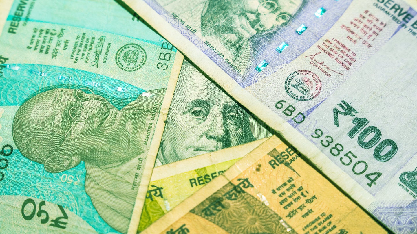 Different denominations of Indian currency notes arranged together, featuring portraits of Mahatma Gandhi and various security features.